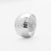 Silver ring with a textured surface on a white background, close-up front view